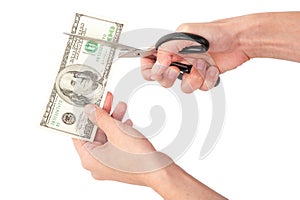 Hands with scissors cutting money