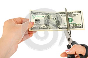 Hands with scissors cutting money