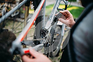 Hands with screwdriver repair shifter, bike repair