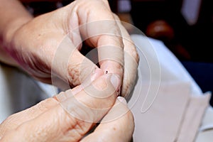 Hands of seamstress at work on the wooden chair with her cloth , hand made soft toys sewing with felt and needle