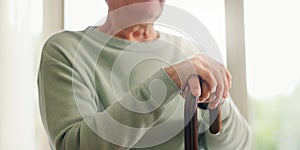 Hands, senior and walking stick, person with a disability and closeup with wellness. Elderly care, cane to help with