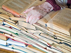 Hands of senior woman with books. Education and knowlege concept