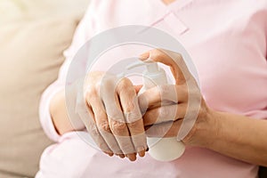 Hands senior woman with moisturizing cream closeup