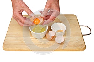 Hands separating eggs