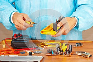 Hands service engineer of electronic equipment in service workshop photo