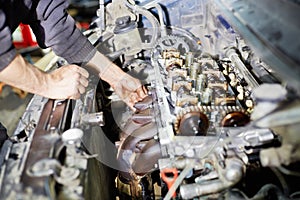Hands servicing car engine photo