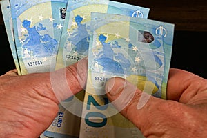 Hands several cash twenty euro bills, recalculation banknotes. Parsimony, savings, home finance