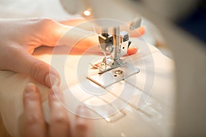 Hands at sewing machine