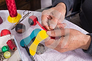 Hands sewing pelota balls photo