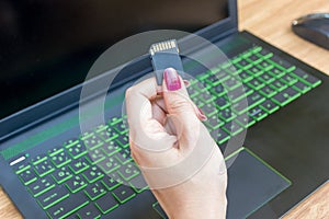 Hands show memory card of laptops user on working