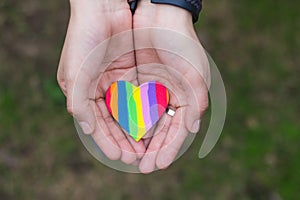 Hands showing a rainbow heart