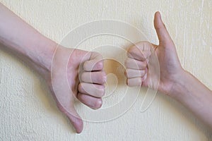 Hands showing thumb up and thumb down