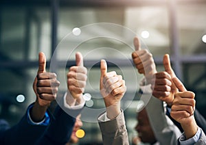 Hands showing thumbs up with business men endorsing, giving approval or saying thank you as a team in the office photo