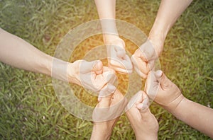 Hands showing thumbs up over green natural background