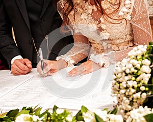 Hands signing during the wedding