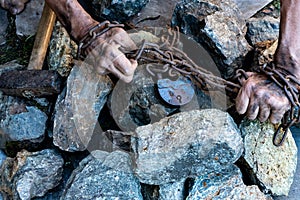 The hands of a slave in an attempt to release. The symbol of slave labor. Hands in chains