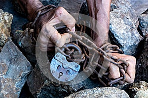 The hands of a slave in an attempt to release. The symbol of slave labor. Hands in chains