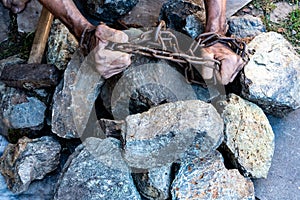 The hands of a slave in an attempt to release. The symbol of slave labor. Hands in chains