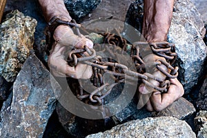 The hands of a slave in an attempt to release. The symbol of slave labor. Hands in chains