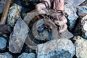 The hands of a slave in an attempt to release. The symbol of slave labor. Hands in chains