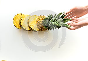 Hands with sliced fresh pineapple