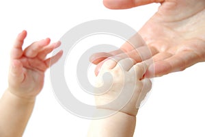 Hands of a small newborn baby hold on to fingers