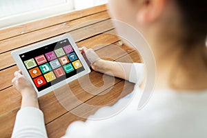 Hands with smart home icons on tablet computer