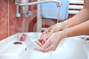 Hands with soap under runnig water