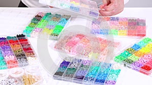 Hands sort through wide selection of colorful crafting beads