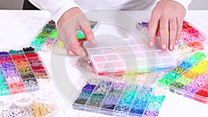 Hands Sort Through Wide Selection of Colorful Crafting Beads