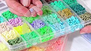 Hands Sort Through Wide Selection of Colorful Crafting Beads