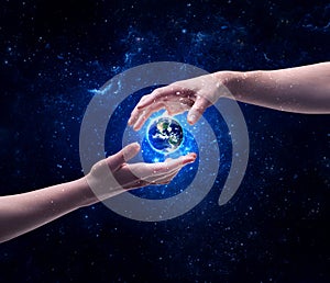 Hands in space touching planet earth