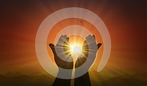 Hands with spark of hope, the light of faith, orange sunset background photo