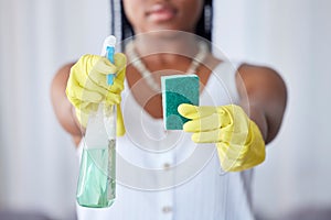 Hands, spray bottle and sponge with a black woman cleaner in a home for housework, hygiene or cleaning. Gloves, spraying