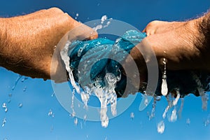 Hands squeeze cloth.