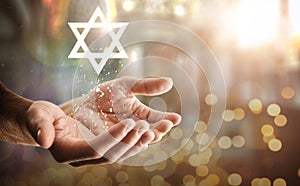 Hands and star floating with glitters and religious background