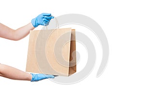 Hands in sterile gloves of a courier for the safe delivery of food.