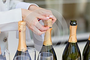 Hands of the steward opening bottles photo