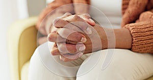 Hands, stress and senior woman on a sofa with anxiety, fear or grief, dementia or scared in her home. Stress, worry and