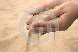 Hands strew sand