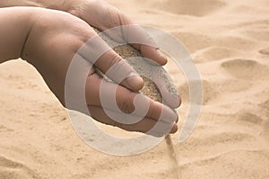 Hands strew sand photo