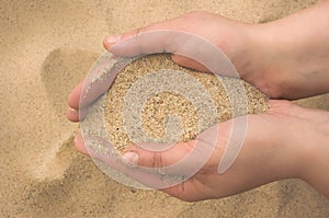 Hands strew sand photo