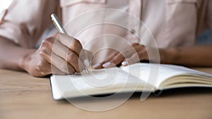 Hands of student girl, writer, author making notes in notebook