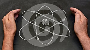 Atom symbol drawn on a blackboard photo