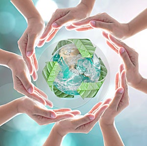 Hands surrounding green planet protected by recycle sign leaf on blurred bokeh .Elements of this image furnished by NASA