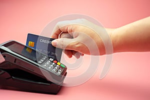 Hands swiping Credit card on Credit card machine or Credit card Terminal, Finance concept