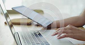 Hands, tablet and laptop for work in office, digital and scroll on screen with computer for research. Person, technology