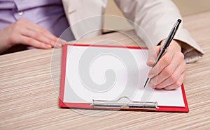 Hands taking notes in the pad