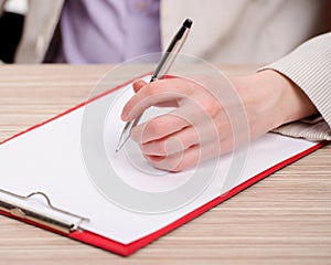 Hands taking notes in the pad