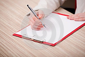 The hands taking notes in the pad